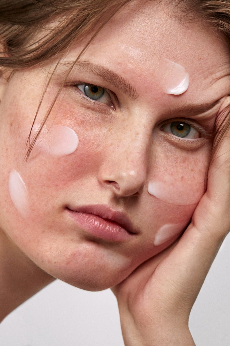 a woman's face with moisturizer