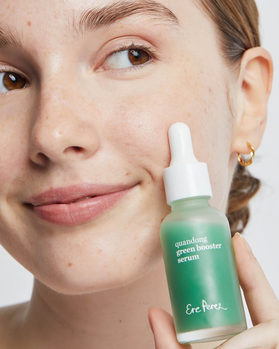 Ere Perez Quandong Green Booster Serum next to face