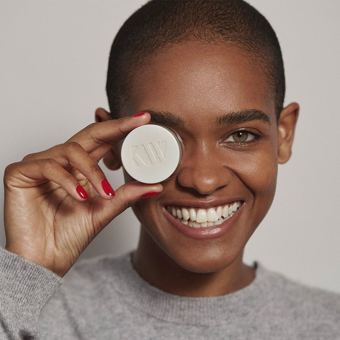 Kjaer Weis The Beautiful Eye Balm - model holding the balm