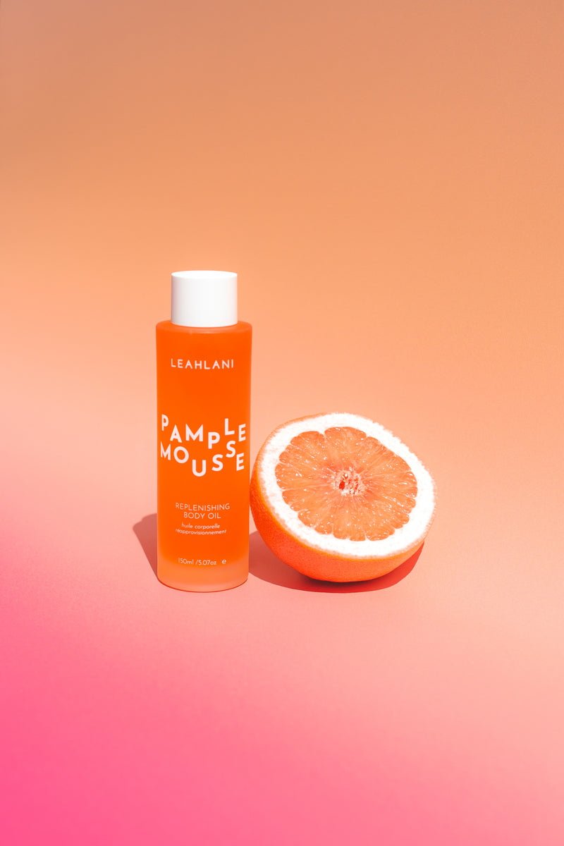 Leahlani Pamplemousse Replenishing Body Oil still life with grapefruit