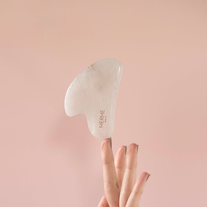 Merme Berlin Rose Quartz Gua Sha Balanding on finger