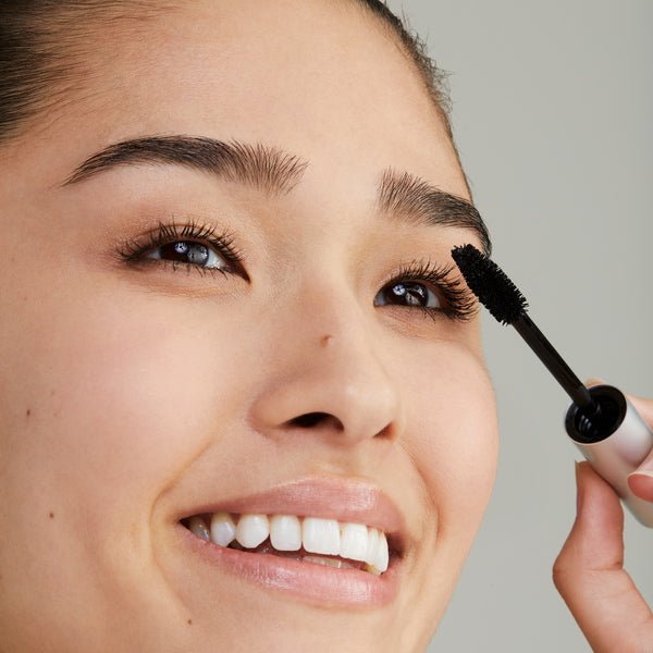 RMS Beauty Straight Up Volumizing Peptide Mascara - model applying mascara